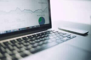Laptop displaying analytical graphs and charts, enhancing business insights, available at Elevate Your Organization's Culture and Performance With CEEK.