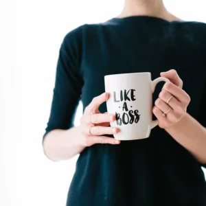 Person holding "Like a Boss" mug, symbolizing leadership, only available at Elevate Your Organization's Culture and Performance With CEEK.
