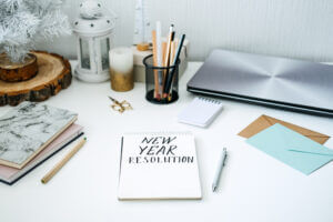 New year resolution notebook on desk, perfect for goal setting with Elevate Your Organization's Culture and Performance With CEEK.