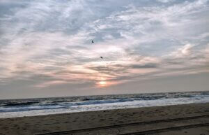 Sunset over ocean waves with a tranquil beach setting, only available at Elevate Your Organization's Culture and Performance With CEEK.