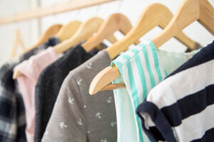 Women's clothes on hangers in a wardrobe, showcasing style and organization, only available at Elevate Your Organization's Culture and Performance With CEEK.
