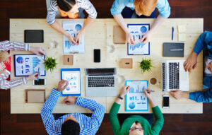 Meeting of accountants analyzing charts and data, enhancing teamwork only at Elevate Your Organization's Culture and Performance With CEEK.