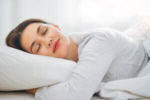Sleeping woman peacefully resting, enhancing well-being at Elevate Your Organization's Culture and Performance With CEEK.