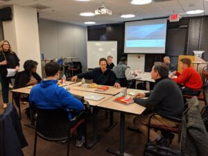 Team meeting in a modern office setting, enhancing collaboration and performance, only available at Elevate Your Organization's Culture and Performance With CEEK.