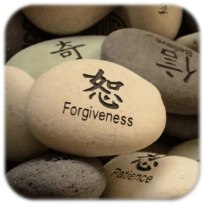 Stone with 'Forgiveness' and Asian character, symbolizing mindfulness, only available at Elevate Your Organization's Culture and Performance With CEEK.