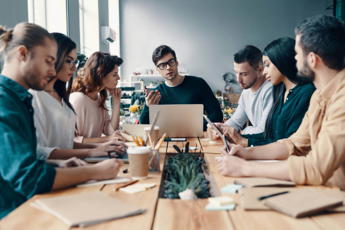 Young professionals in a leadership meeting, enhancing teamwork skills at Elevate Your Organization's Culture and Performance With CEEK.