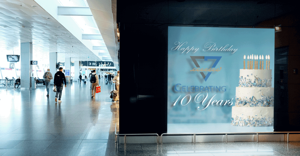 Celebratory 10th anniversary cake display at airport, only available at Elevate Your Organization's Culture and Performance With CEEK.