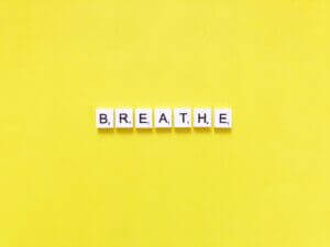 Breathe spelled with letter tiles on yellow background, only available at Elevate Your Organization's Culture and Performance With CEEK.