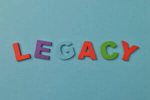Colorful alphabet letters spelling LEGACY on blue, featured by Elevate Your Organization's Culture and Performance With CEEK.