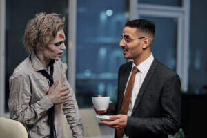 Zombie conversing with office manager, showcasing unique workplace culture, only at Elevate Your Organization's Culture and Performance With CEEK.