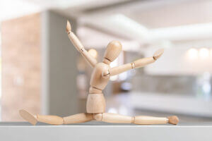 Wooden mannequin in a split pose, symbolizing flexibility and creativity, only at Elevate Your Organization's Culture and Performance With CEEK.
