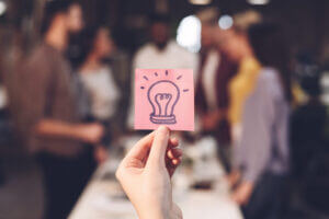 Business idea concept with colleagues discussing startup project, only available at Elevate Your Organization's Culture and Performance With CEEK.