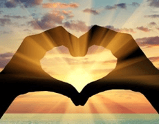 Heart-shaped hands framing a sunset, symbolizing unity and positivity, only available at Elevate Your Organization's Culture and Performance With CEEK.