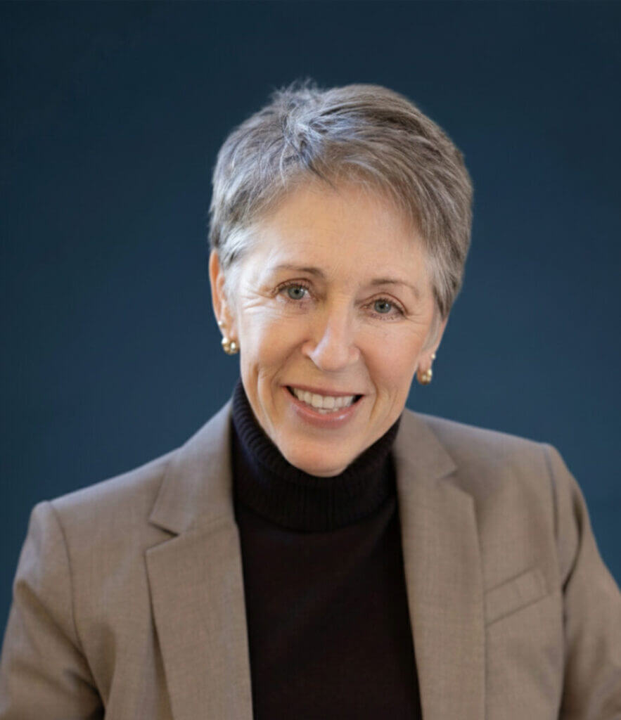 Professional portrait of a smiling woman in a blazer, available at Elevate Your Organization's Culture and Performance With CEEK.